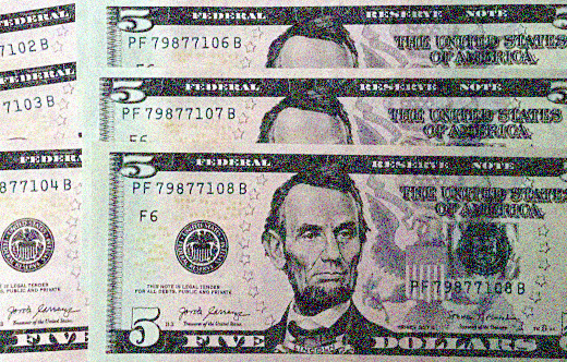 photo of US five dollar bills